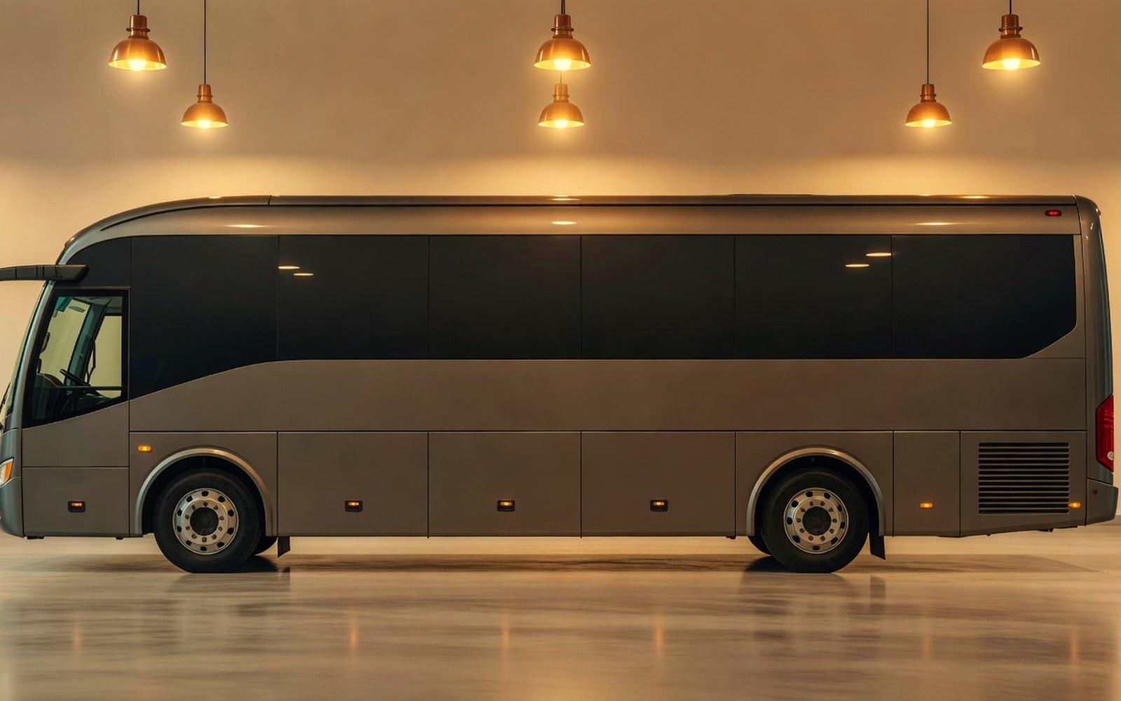 Shuttle bus side windows with consistent dark tint in a warm service bay