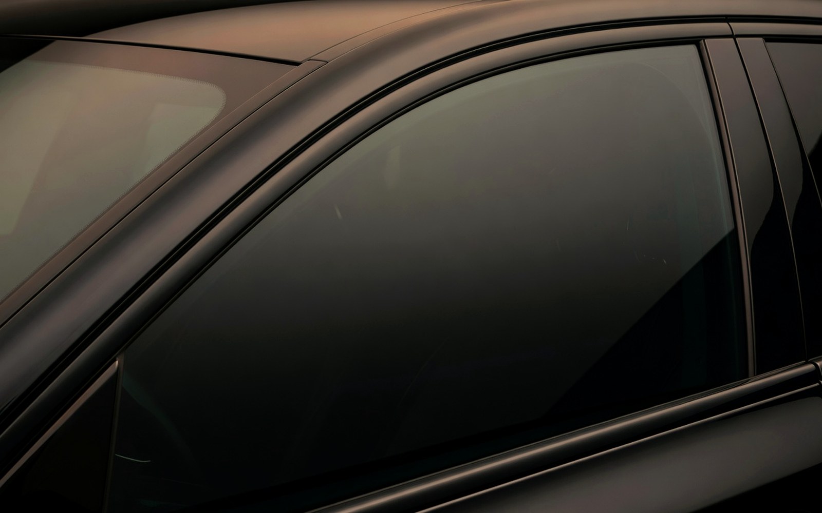 Close detail of clean ceramic tint glass with warm amber studio reflections